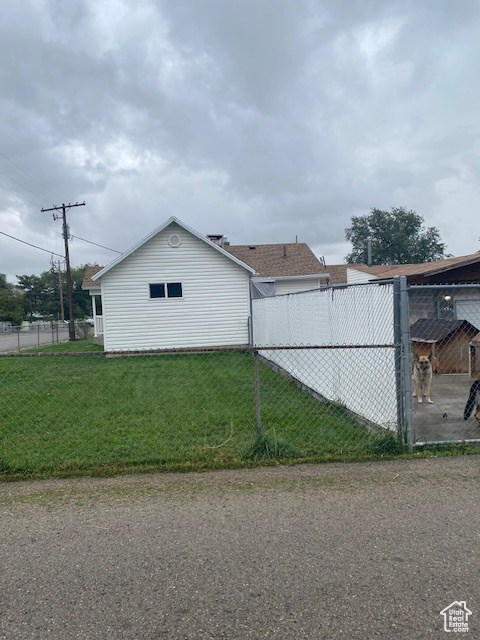 View of side of property featuring a lawn