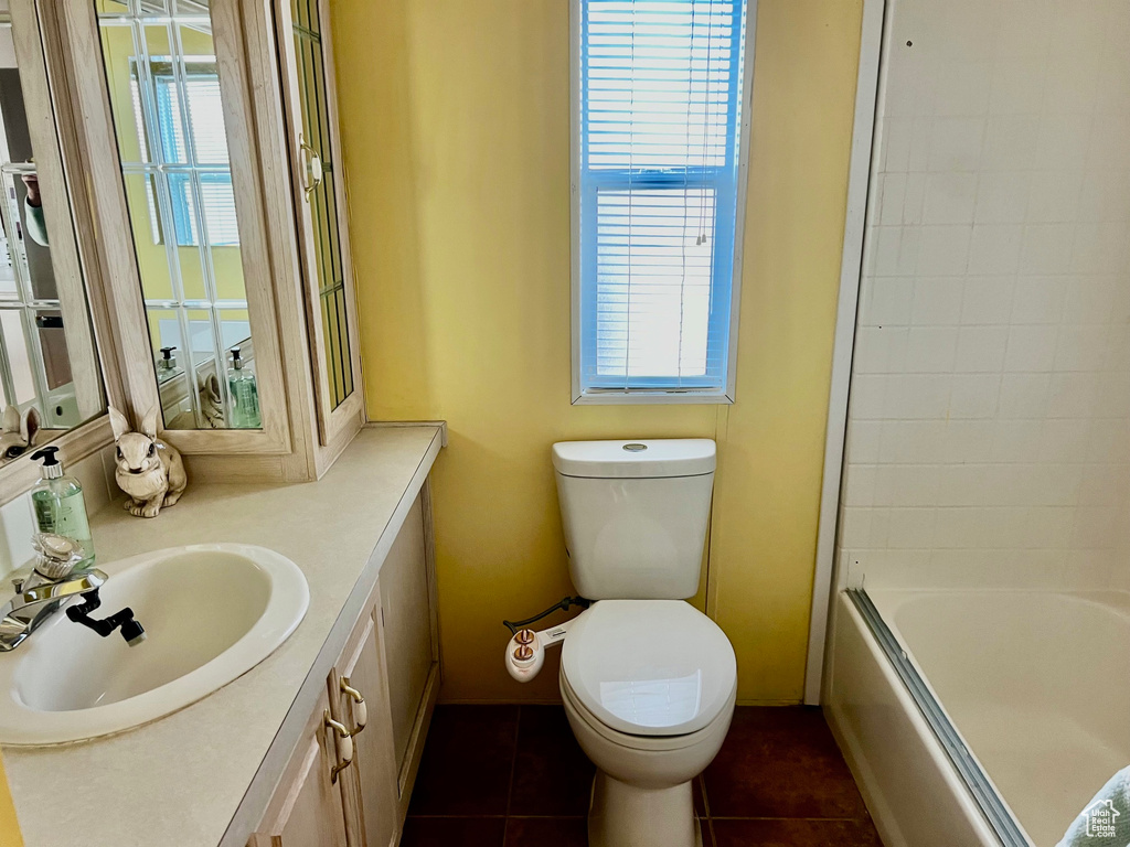 Bathroom featuring shower / bathing tub combination, toilet, vanity, and tile patterned flooring