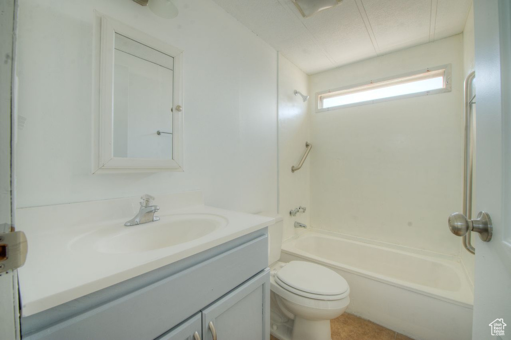 Full bathroom featuring vanity, toilet, and tub / shower combination