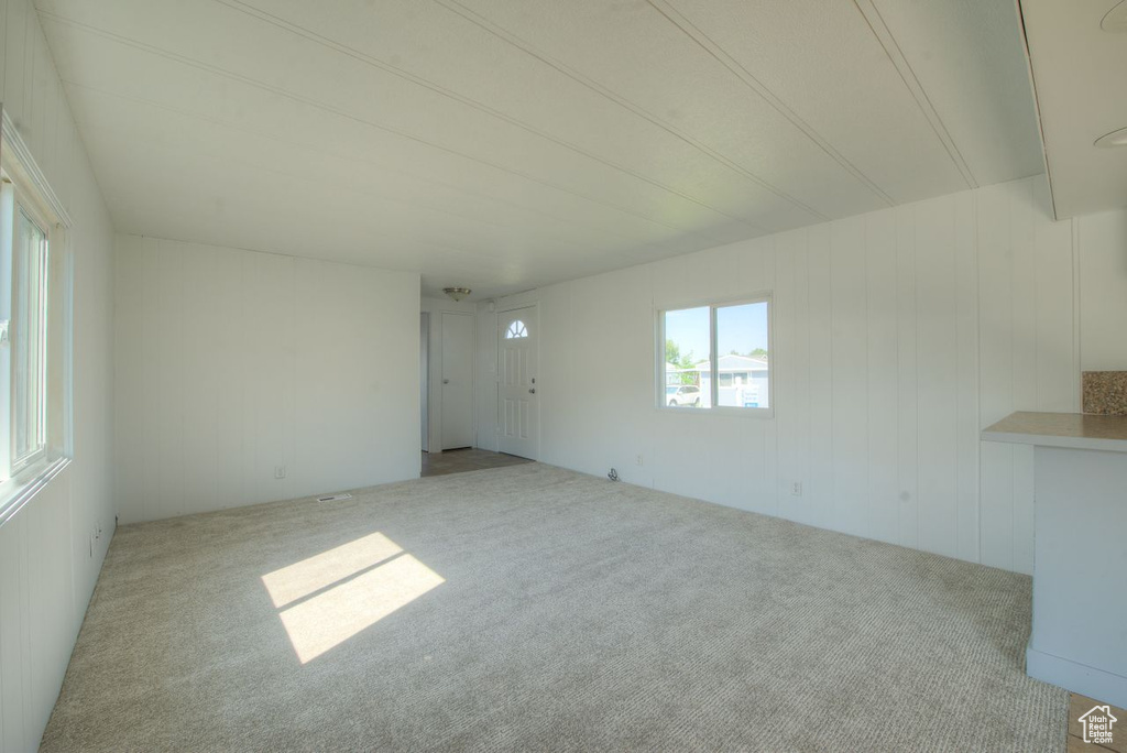 Unfurnished room featuring light carpet