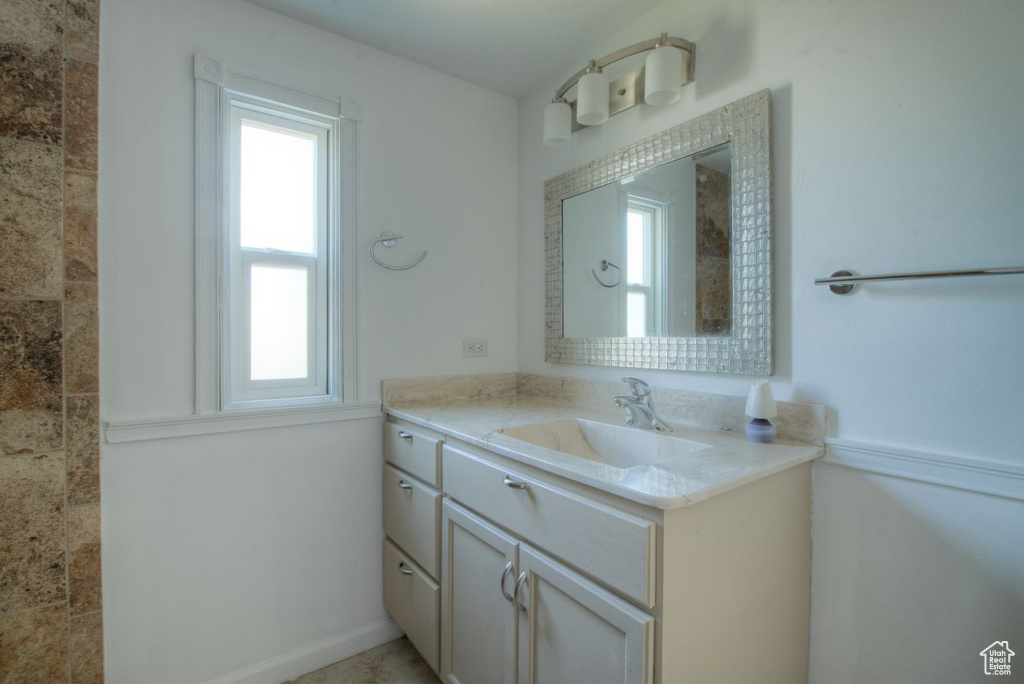 Bathroom with vanity and a healthy amount of sunlight
