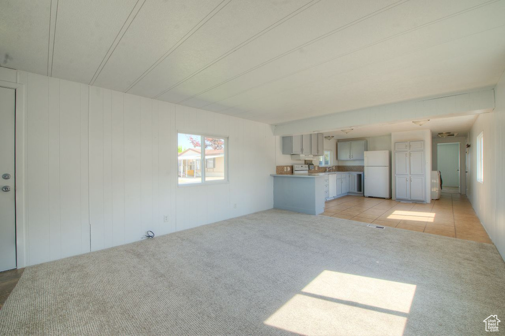 Unfurnished living room with light tile patterned floors
