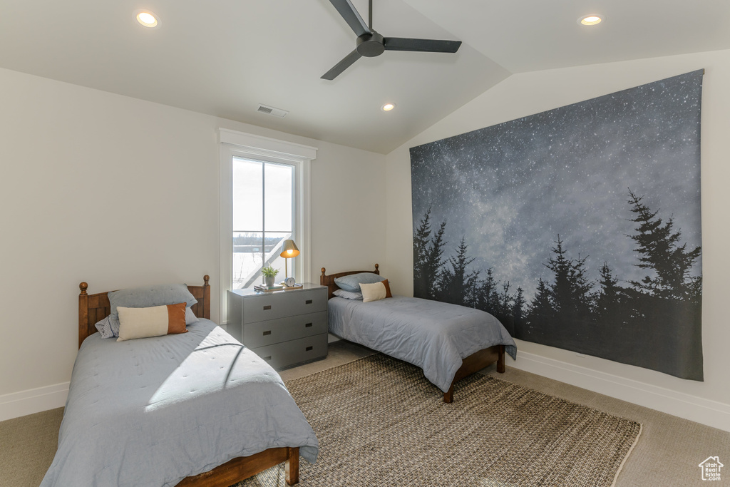 Bedroom featuring lofted ceiling, carpet flooring, and ceiling fan