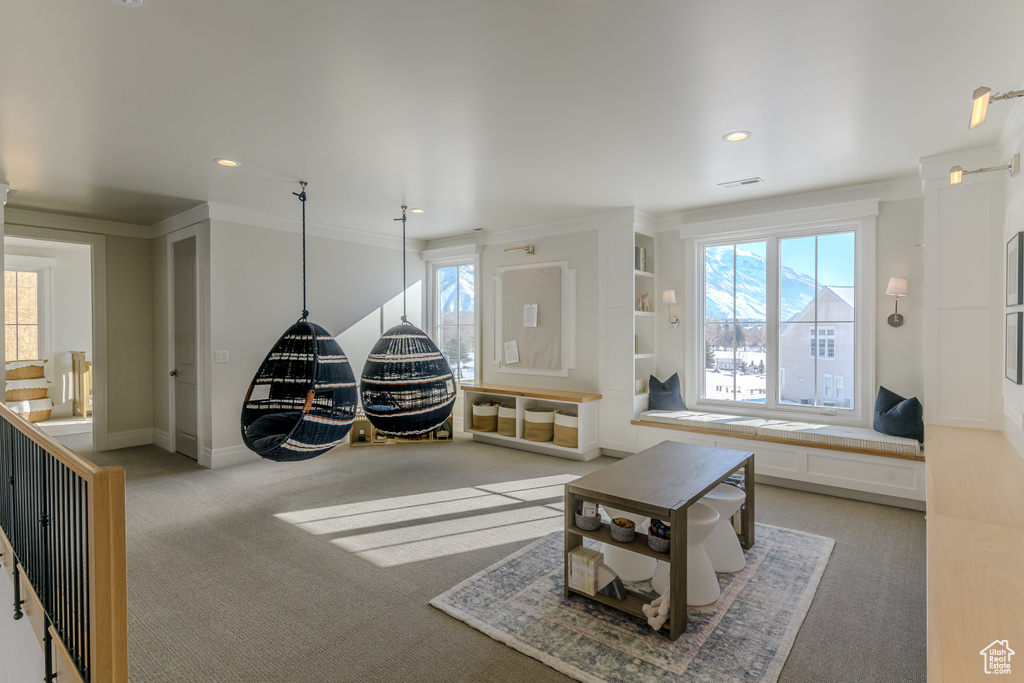 Carpeted living room with ornamental molding