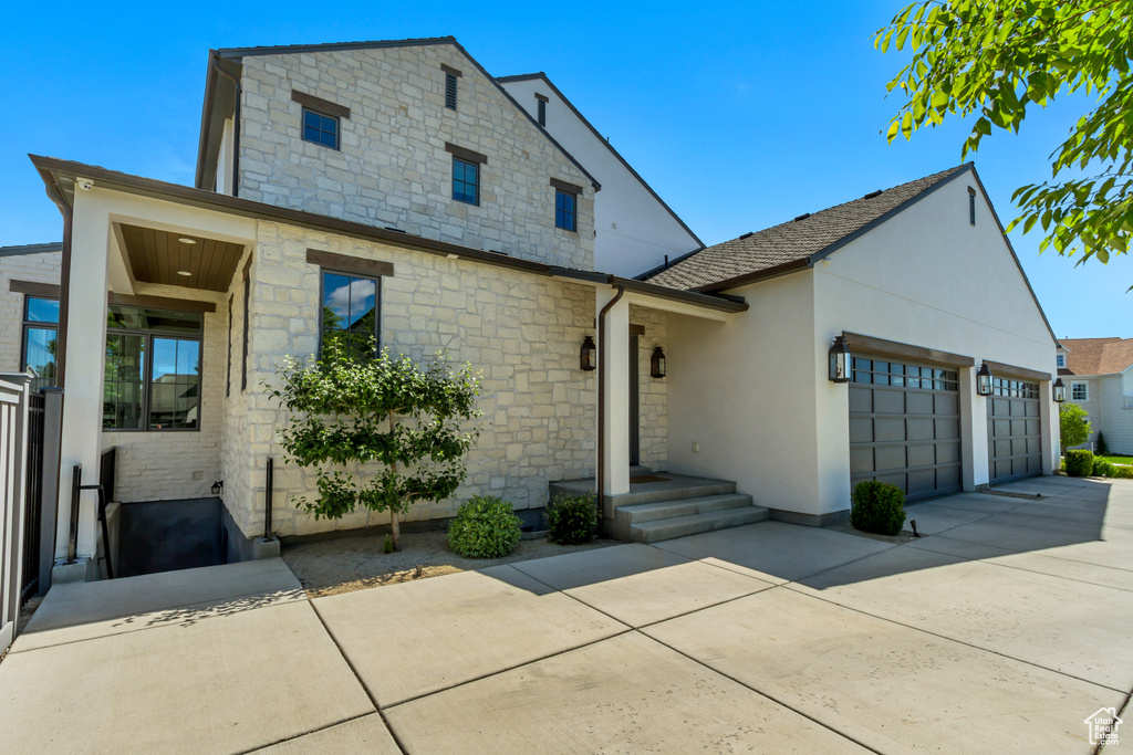 View of front facade featuring a garage