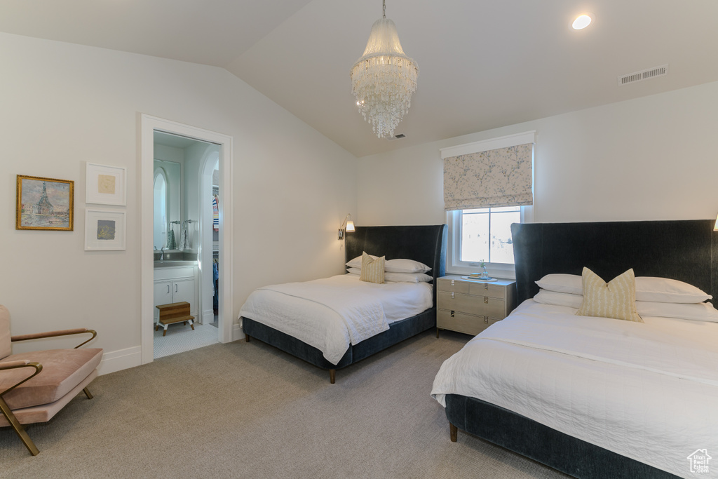 Bedroom with lofted ceiling, carpet floors, ensuite bathroom, and a chandelier