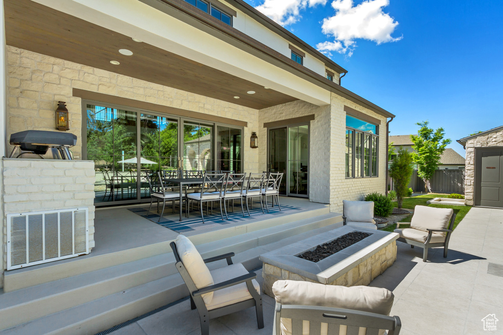 View of patio with a fire pit