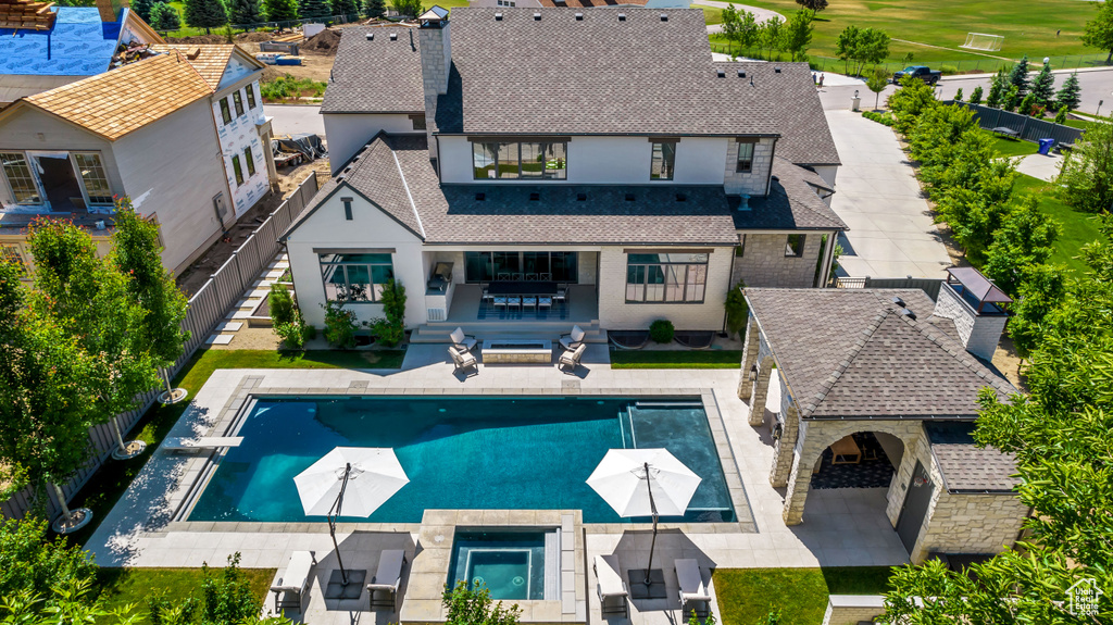 Exterior space featuring a balcony, an outdoor hangout area, a patio, and a fenced in pool