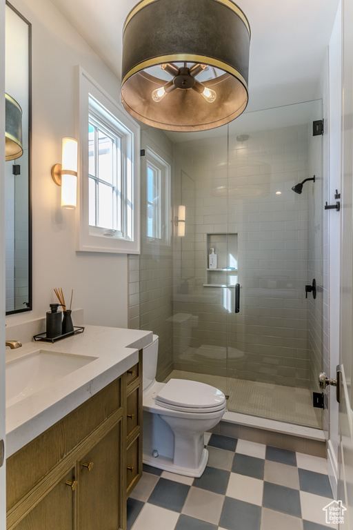 Bathroom with vanity, toilet, and an enclosed shower