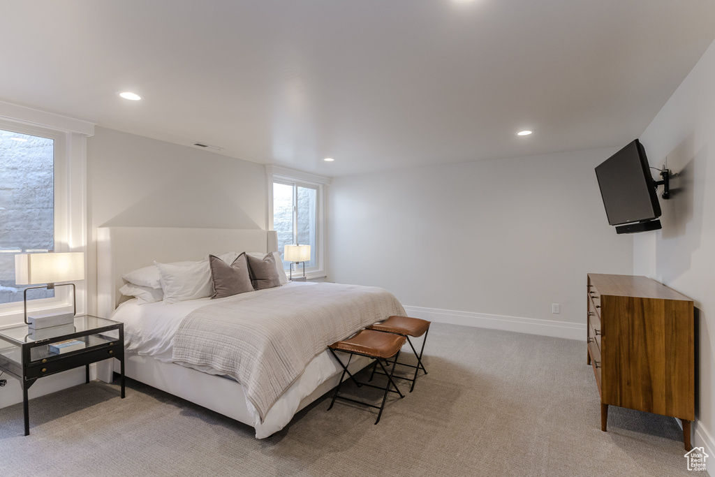 Bedroom featuring light colored carpet