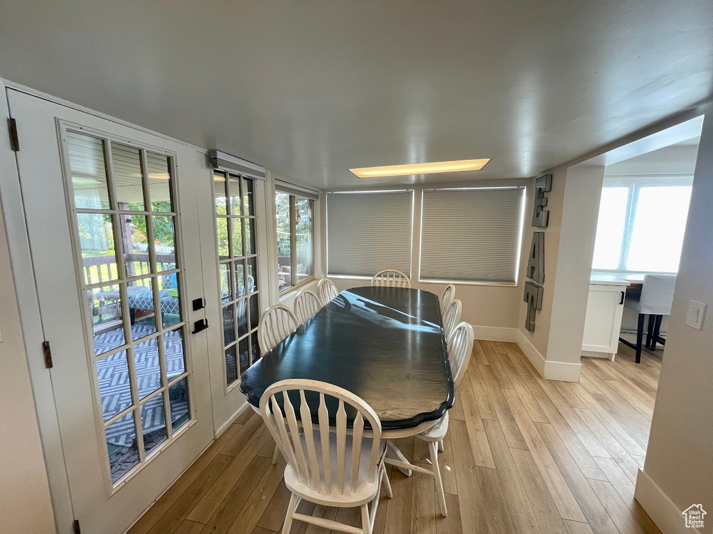 Dining room with a healthy amount of sunlight and light wood-type flooring