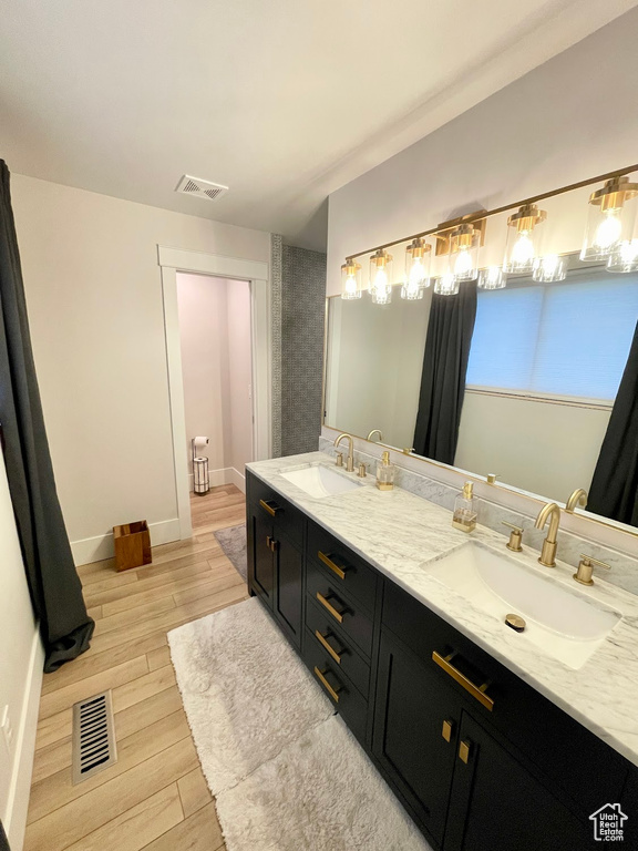 Bathroom featuring hardwood / wood-style flooring and vanity