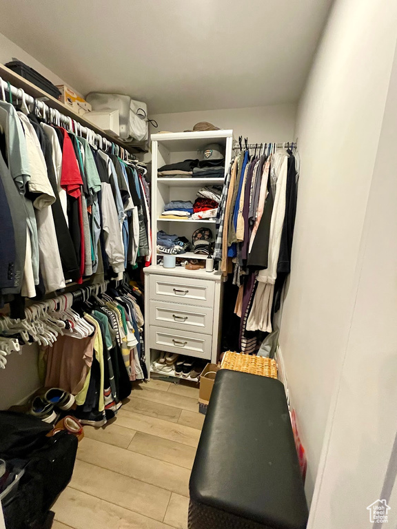 Spacious closet featuring light hardwood / wood-style flooring