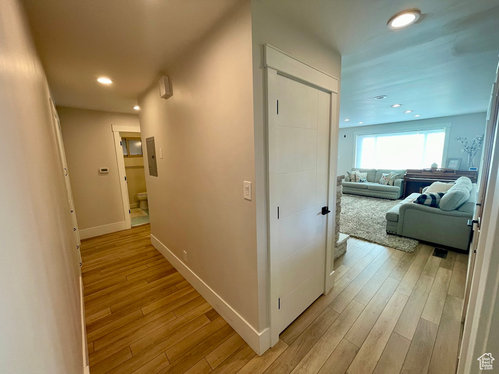 Corridor with light hardwood / wood-style flooring