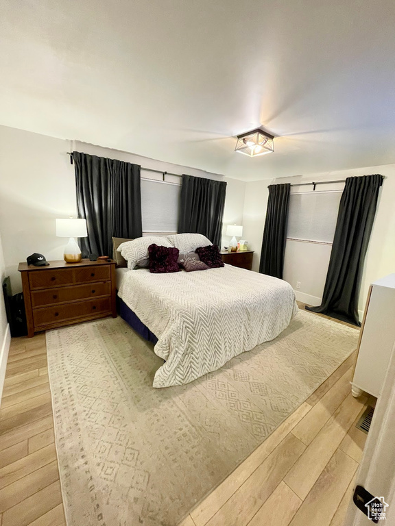 Bedroom with light hardwood / wood-style flooring