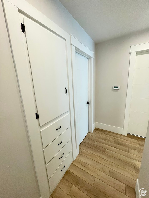 Corridor with light hardwood / wood-style floors