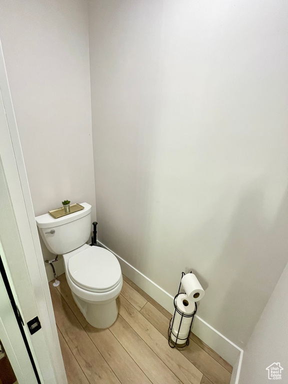 Bathroom featuring hardwood / wood-style floors and toilet