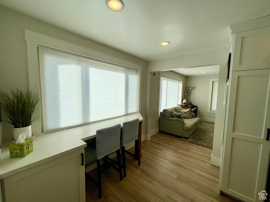 Home office with light wood-type flooring