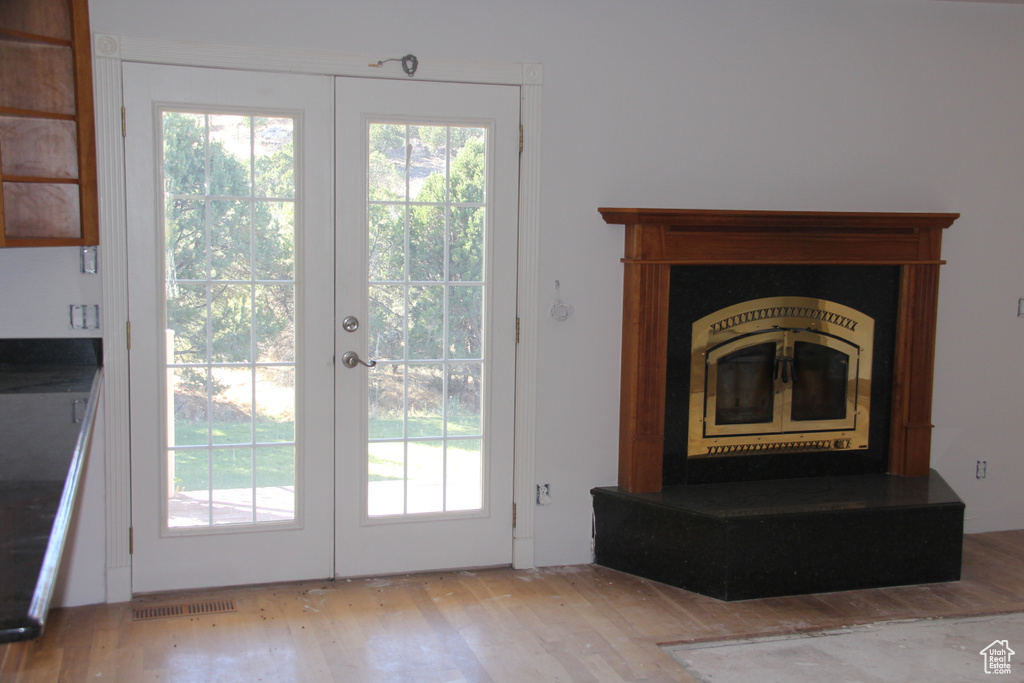 Entryway with french doors and light hardwood / wood-style flooring