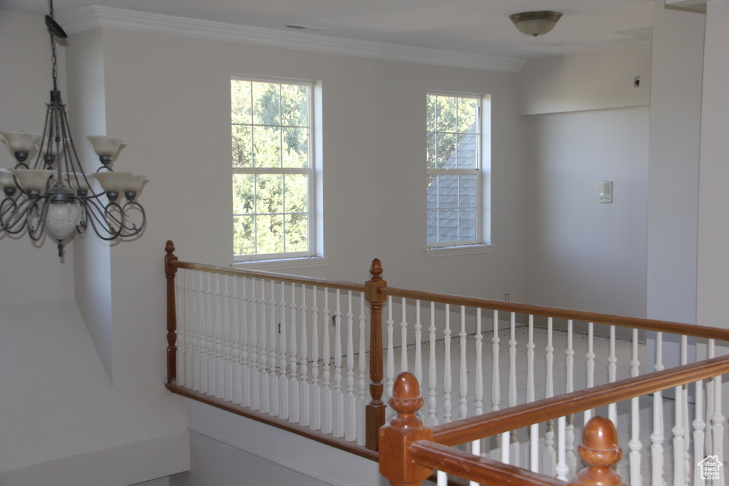Details with an inviting chandelier and ornamental molding