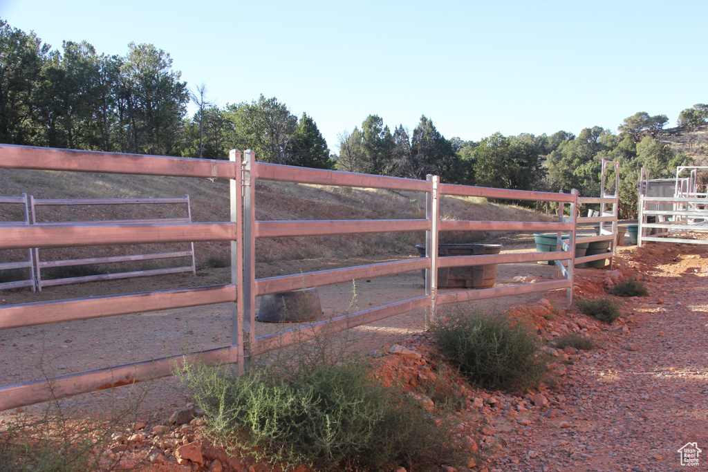 View of gate featuring an outdoor structure and a rural view