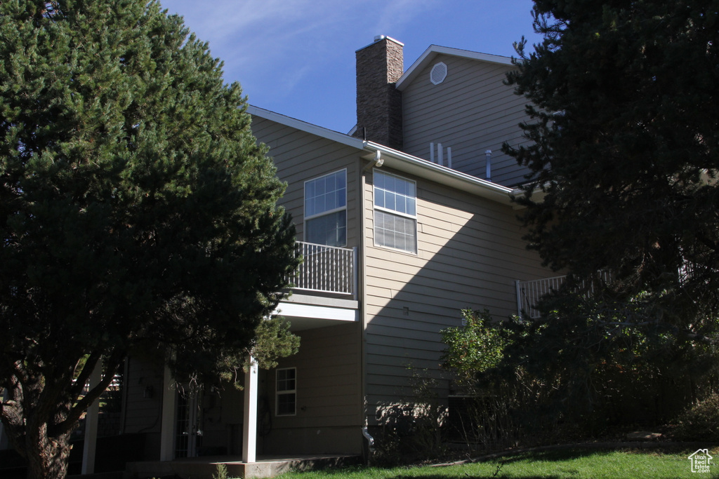 View of side of home featuring a balcony