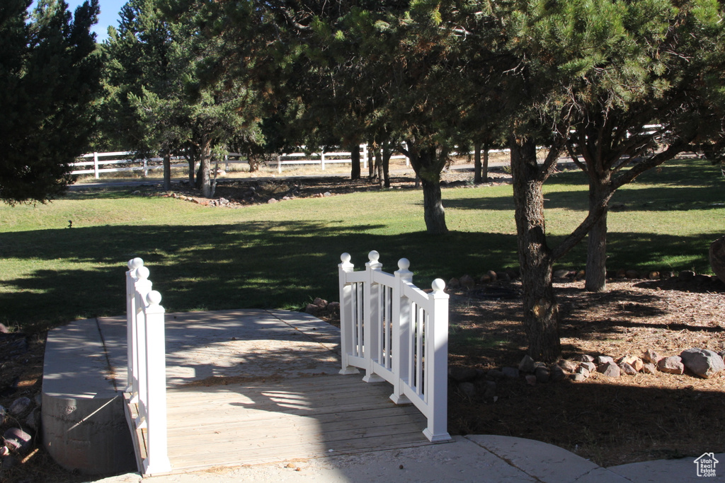 View of dock featuring a lawn and a wooden deck