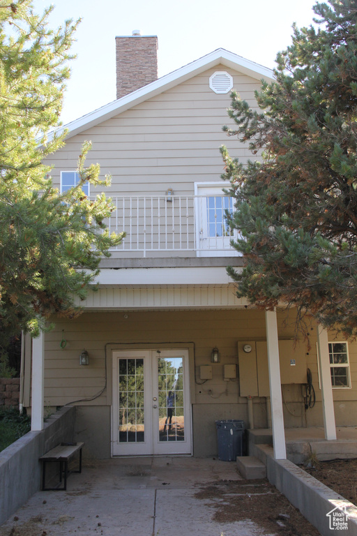 Back of property featuring a patio and a balcony