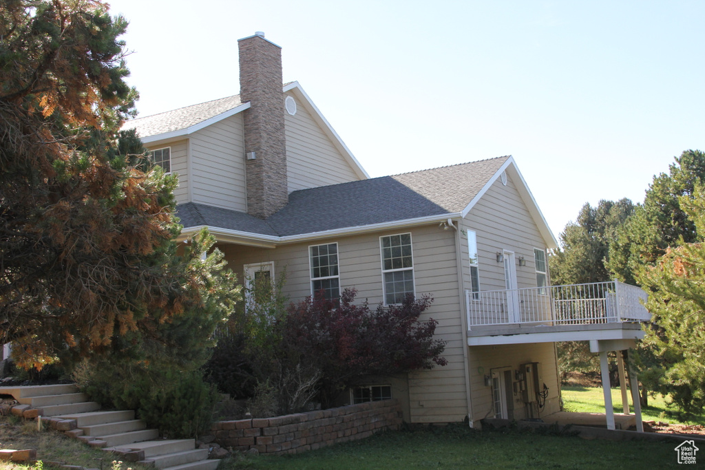 View of side of home with a yard