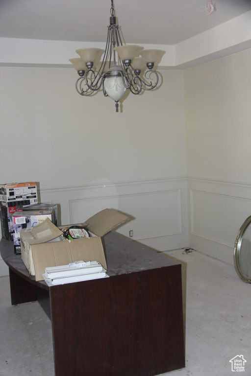 Office space featuring an inviting chandelier
