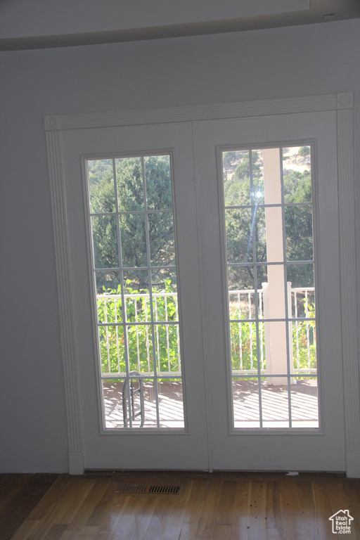 Doorway to outside featuring french doors, hardwood / wood-style flooring, and plenty of natural light
