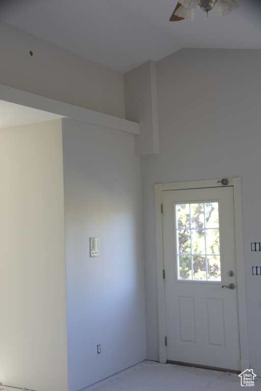 Doorway to outside with lofted ceiling and ceiling fan