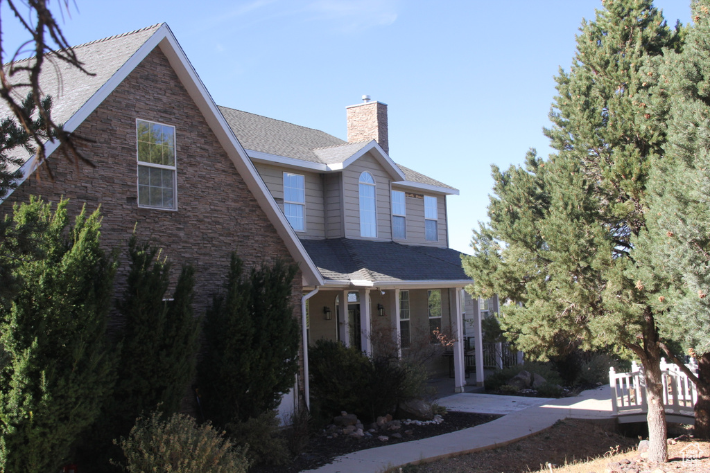 View of side of property with a porch