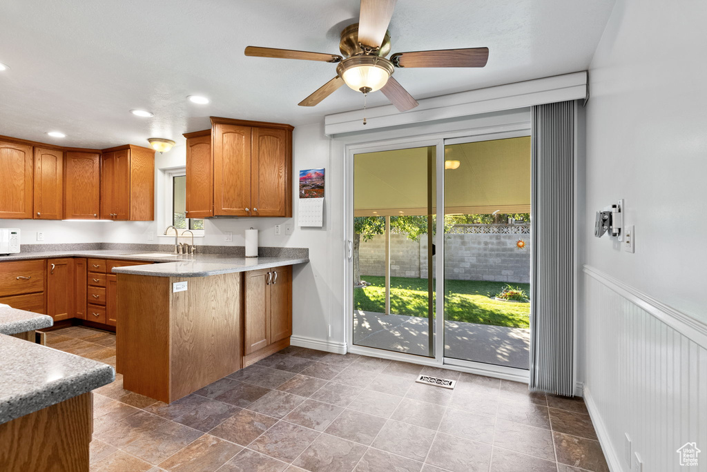 Kitchen with kitchen peninsula, sink, and ceiling fan