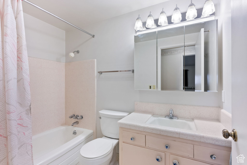 Full bathroom with shower / bath combo, vanity, and toilet