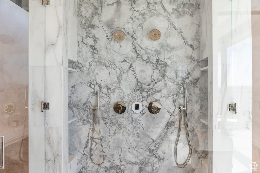 Bathroom featuring a marble finish shower