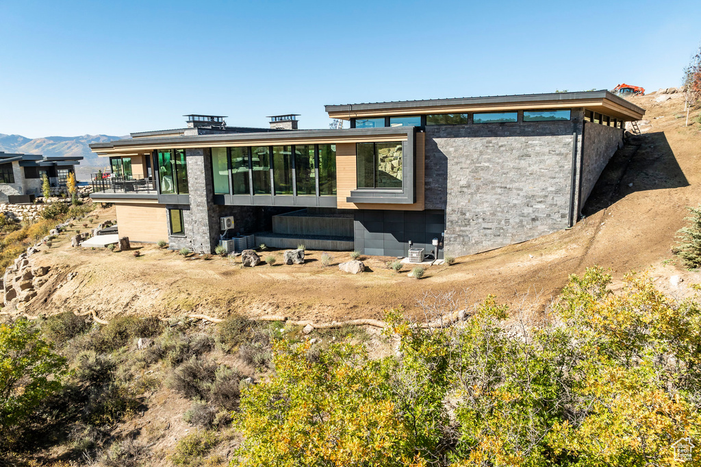 Rear view of house featuring a mountain view