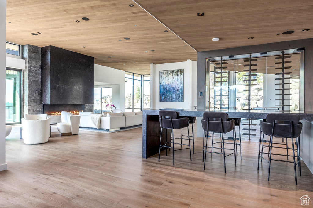 Dining room with wood ceiling, healthy amount of natural light, wood finished floors, and a fireplace
