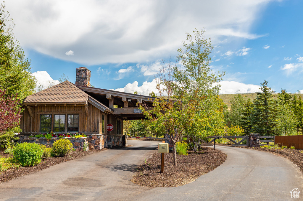 View of community featuring curved driveway and a gate