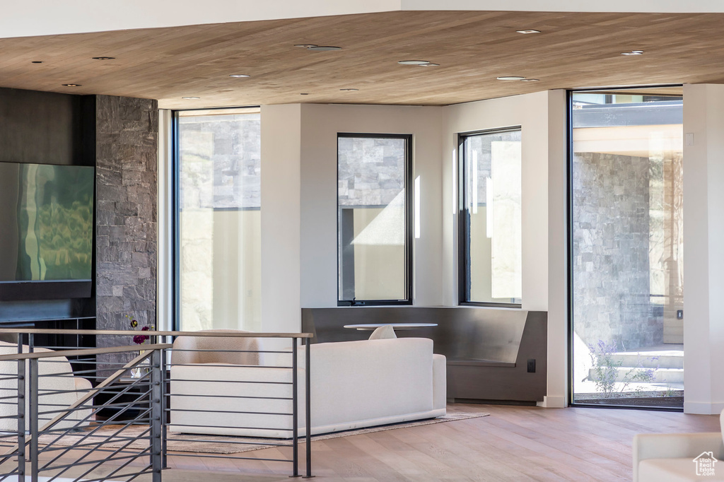 Doorway to outside with wood finished floors, expansive windows, recessed lighting, and wooden ceiling