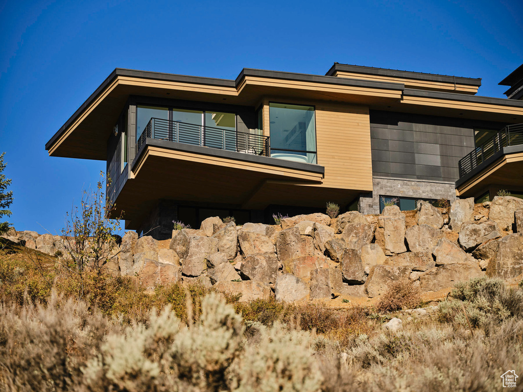 View of side of property with a balcony