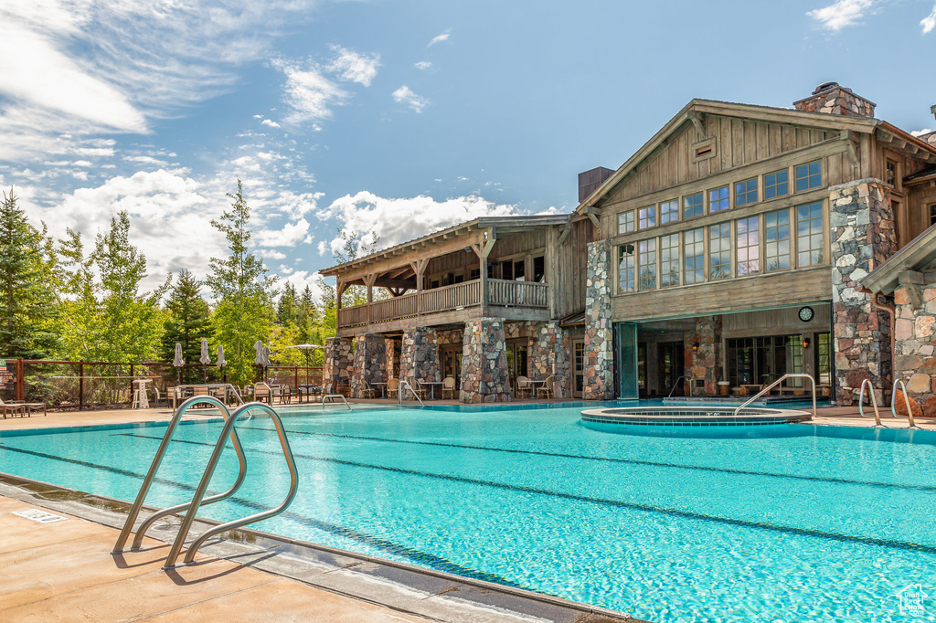 Community pool with fence and a patio