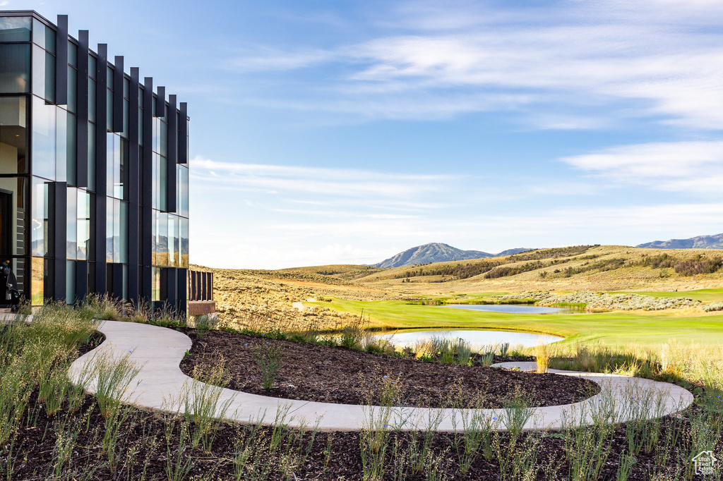 View of property's community with a water and mountain view and view of golf course