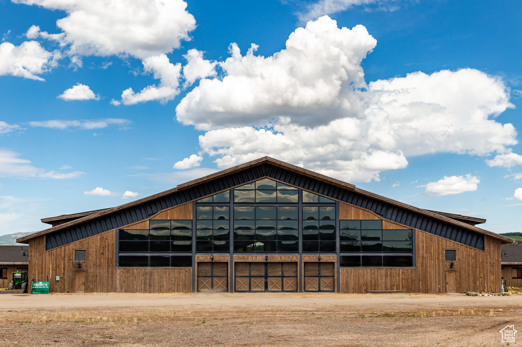 View of building exterior with dirt driveway