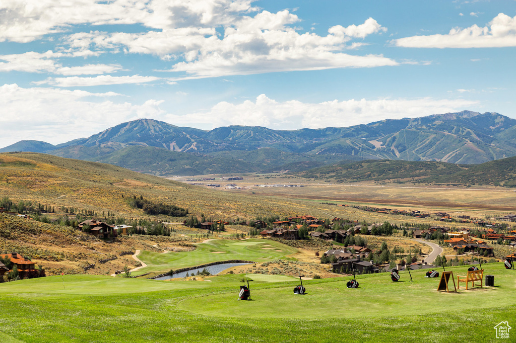 View of mountain backdrop with a golf club and a large body of water