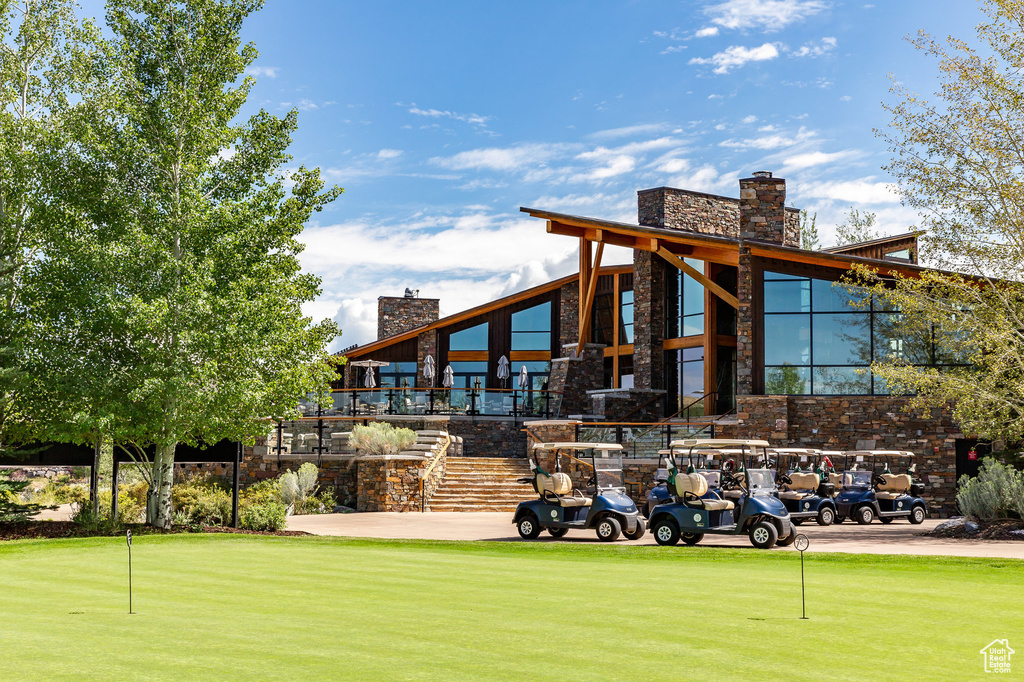 View of community featuring an area to practice putting and stairs