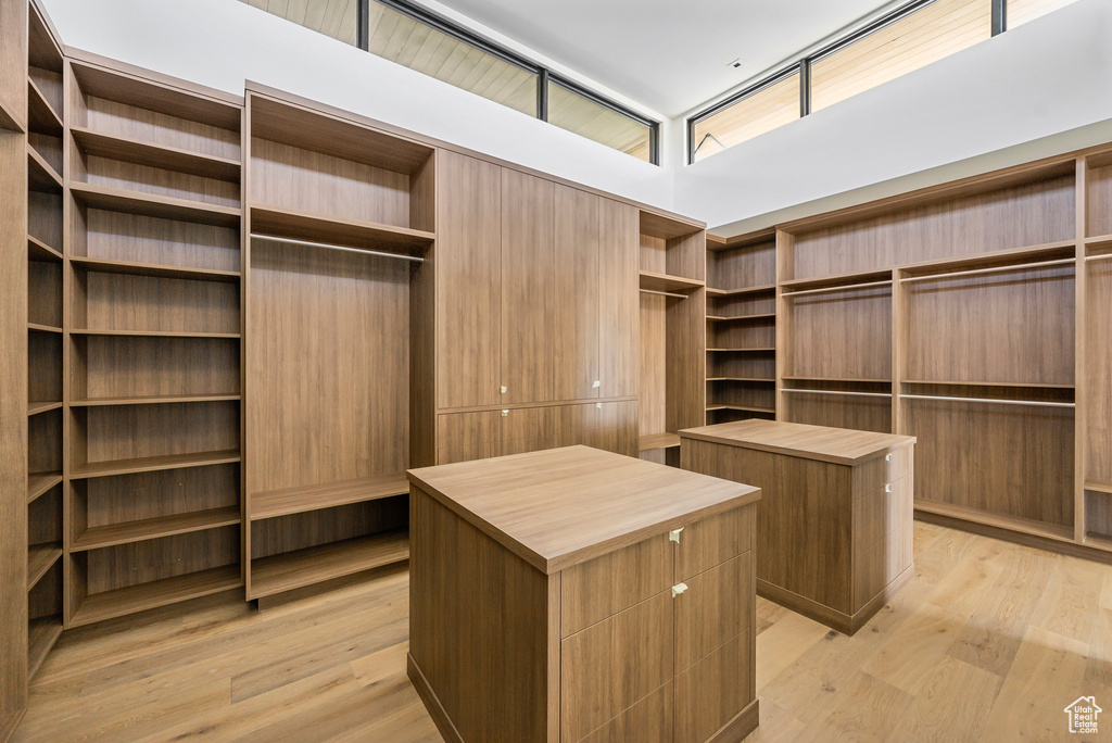 Walk in closet with light wood-type flooring