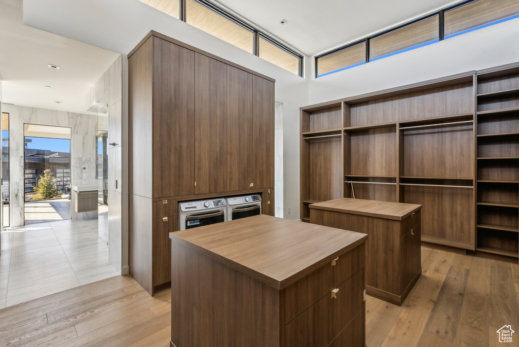 Spacious closet with washer and dryer and light wood-type flooring