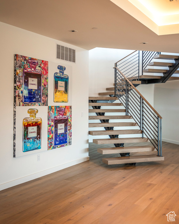 Stairway featuring wood finished floors and baseboards