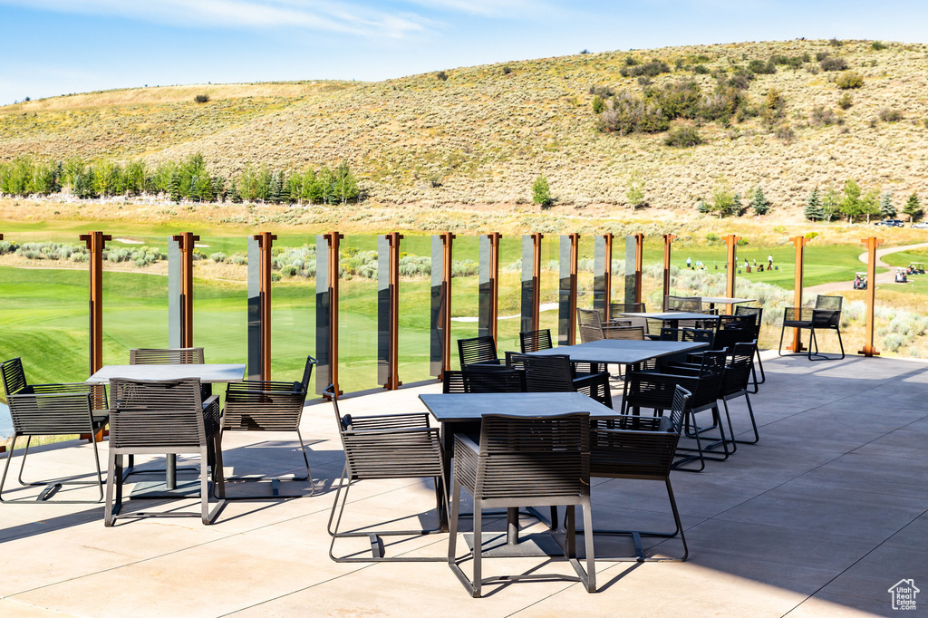 View of patio featuring outdoor dining area and golf course view